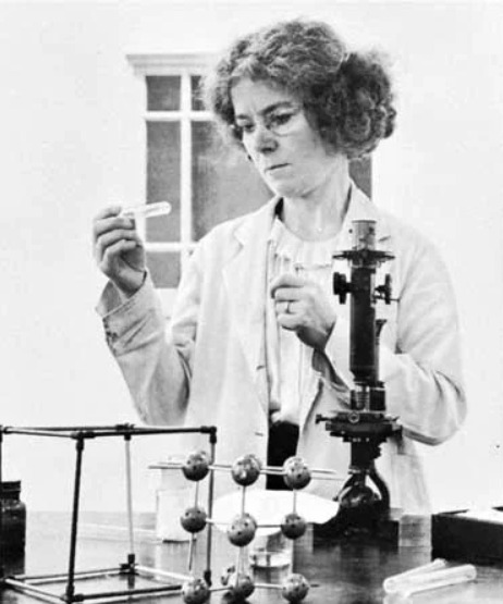 Lonsdale engaged in an experiment featuring a test tube and a microscope.&nbsp;