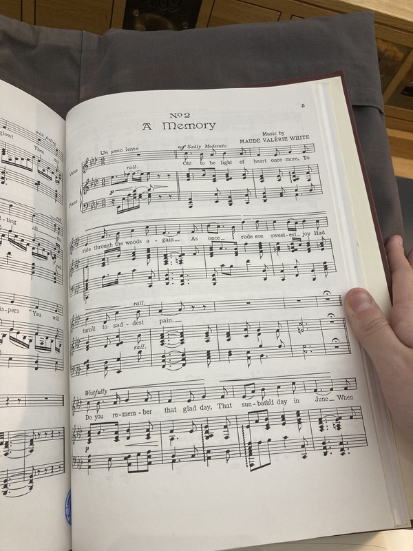 Photo of the title page of the second movement of Three Little Songs entitled "No 2. A Memory". It was composed by Maude Val&eacute;rie White and contains original lyrics.
