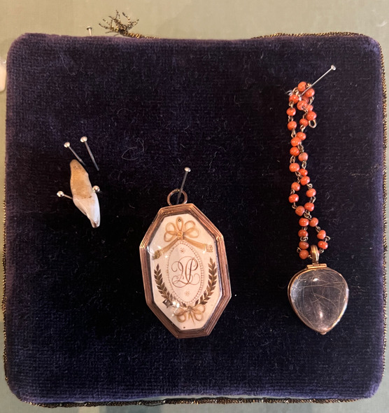 A fragment of the tooth, necklace, and emblem of Katherine Parr that were stolen from her grave during a violent robbery that destroyed what remained of her body. The items were eventually returned to Sudeley Castle.