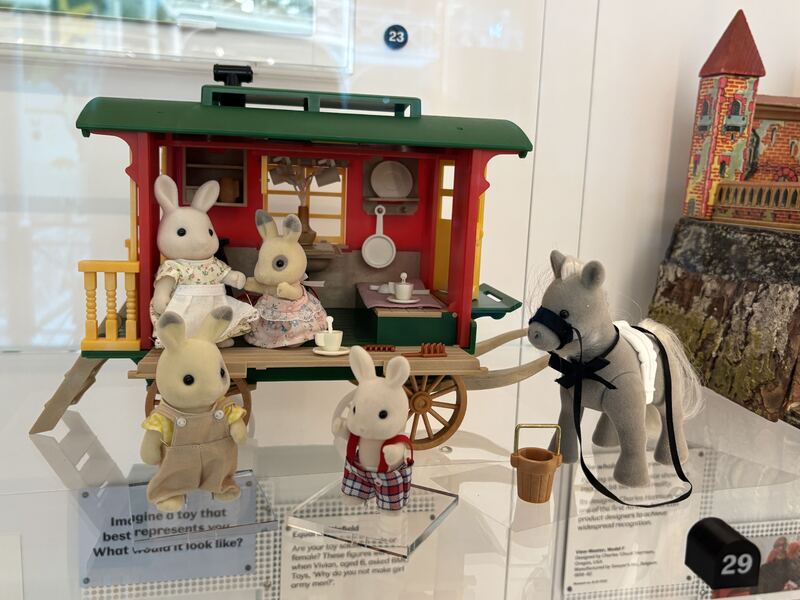 The Sylvanian Families Horse Drawn Caravan offers a charming glimpse into a nomadic lifestyle often romanticized in British culture. Pulled by a gentle grey horse with a harness, the green and red caravan features a cozy interior with windows, a door, and even a small cooking area visible. This playset evokes images of traditional Romani caravans and the history of traveling communities in Britain, representing a sense of freedom and connection to the countryside. It's a sweet miniature portrayal of a mobile home, reminiscent of vintage British fairground or countryside living.