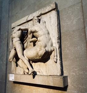 This metope, one of fifteen in the British Museum's permanent collection, depicts chaos erupting between a Lapith and a centaur. The metope is severely damaged, with the Lapith missing both his head and his right leg, below the knee. The centaur is missing both his head, as well as his front right leg.