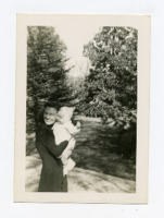 Photograph of Marnie Henson being held by an unidentified woman.