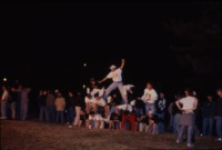 Sigma Nu brothers build a human pyramid at the 2001 Homecoming bonfire.