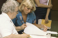 History faculty member Frances Roberts working with a student at registration.