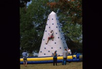 Students climbing a rock wall at Spring Fest.