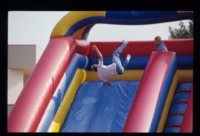 Students on an inflatable slide at Spring Fest.