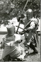 Members of the Society for Creative Anachronism demonstrating a medieval duel in full armor.
