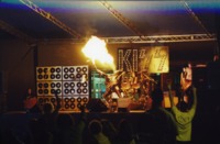 The lead singer of a KISS tribute band breathing fire onstage at Spring Fest 2001.