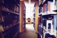 Student in the stacks at the UAH Library.