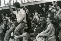 Fans celebrating in the stands at a UAH basketball game.