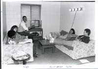 Students socialize in a dormitory common area.