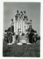 Cheerleaders posing around the UAH statue.