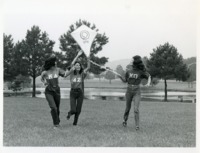 UAH sorority members flying a kite at the campus lake.