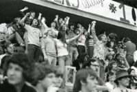 Fans cheer in the stands at a UAH sporting event.