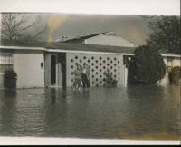 Students wading in floodwater at UAH Community Housing. 