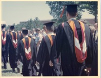Members of the class of 1970 processing through the crowd at commencement.