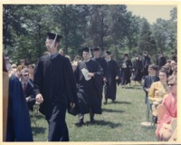 Members of the class of 1970 processing through the crowd at commencement.