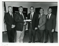 UAH President Frank Franz accepting a $10,000 check from TRW System Development Division.