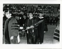 Mace bearer marching at UAH graduation.