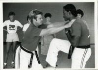 Kevin O'Connell and Berry Grizzard giving a self-defense demonstration.