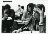 Students take notes in class at UAH.
