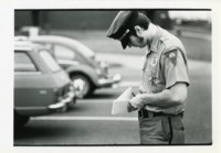 A UAH campus police officer writes a ticket.