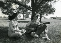 Students socialize near the campus lake.