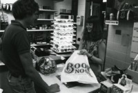 Student making a purchase at the UAH Book Nook.