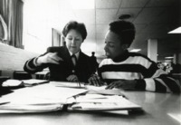 Navy Lieutenant Teresa Cissell, a UAH graduate, helps eleven-year-old Denis in the Navy Kids Program.