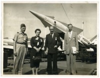 Frances C. Roberts standing in front of a display of U.S. Army missiles at Redstone Arsenal.