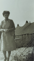 Photograph of a nurse outside of the 95th Evacuation Hospital Building.
