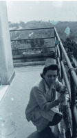 Photograph of a nurse leaning on a balcony at the 300th General Hospital in Naples, Italy.