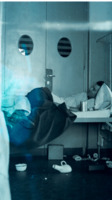 Photograph of a man in a bed at the 300th General Hospital in Naples, Italy.