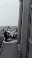 Photograph of a man reclining on a balcony at the 300th General Hospital in Naples, Italy.