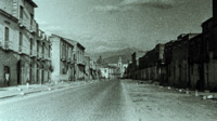Photograph of a road through an Italian city.