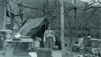 Man standing outside of a tent in Italy.