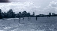 Men running in a field at the Carolina maneuver area.