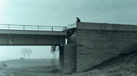 Photograph of  vehicle and a beam bridge.