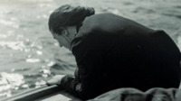 Photograph of a nurse looking over the side of a boat, Great Britain.
