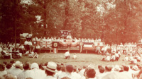 View of the stage and the crowd at a gubernatorial campaign event for Jim Folsom at Monte Sano State Park.