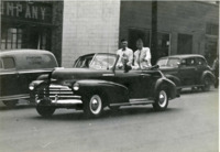 Photograph of men in a parade in downtown Huntsville, Alabama. 