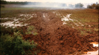 Photograph of drainage holes from explosives on Burwell farm.