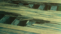 Detail of a damaged wooden bridge.