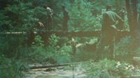National Guard soldiers at work building a wooden bridge.