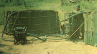 National Guard soldier with a water decontamination unit.