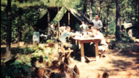 Soldiers sharing a meal at a National Guard camp bivouac site.