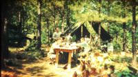 Soldiers at a bivouac site sharing a meal at a National Guard camp.