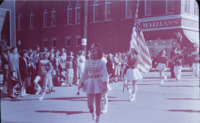 Scene of parade marchers with color guard in downtown Huntsville.