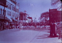 Cheerleaders and marching band march through Courthouse Square in downtown Huntsville.
