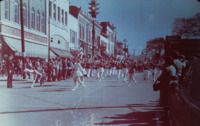 Cheerleaders and a marching band march in a parade on the east side of Courthouse Square in downtown Huntsville.